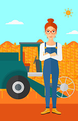 Image showing Woman standing with combine on background.