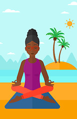 Image showing Woman meditating in lotus pose.