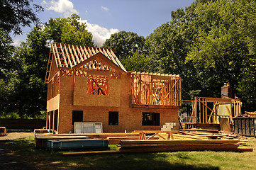 Image showing A residential home under construction mid framing and sheathing