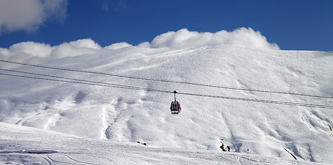 Image showing Panoramic view on gondola lift and ski slope at sun day