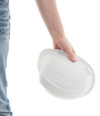 Image showing Male engineer in jeans holding white hardhat