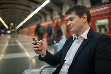 Image showing Businessman with smartphone in subway