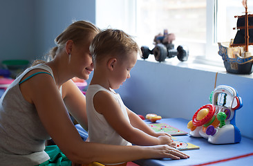 Image showing Mother playing learning game with son