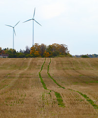 Image showing Two wind turbines in the field.