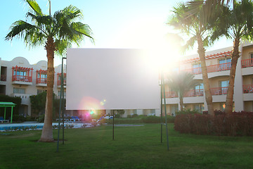 Image showing Sun flare behind a blank urban billboard