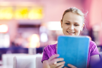 Image showing Woman using tablet PC in the restaurant indoors