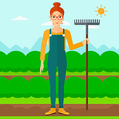 Image showing Farmer with rake.