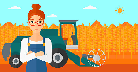 Image showing Woman standing with combine on background.