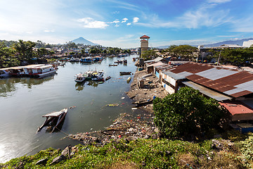 Image showing poor houses by the river in shantytown