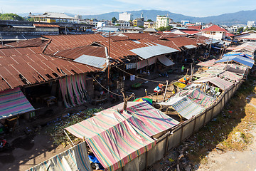 Image showing poor houses by the river in shantytown