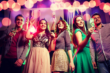 Image showing smiling friends with glasses of champagne in club