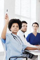 Image showing group of happy doctors on conference at hospital