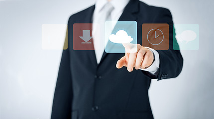 Image showing close up of man pointing finger to cloud icon