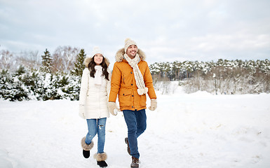 Image showing happy couple walking along snowy winter field