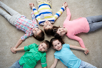 Image showing happy smiling little children lying on floor