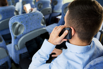 Image showing man with smartphone and laptop in travel bus