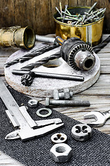 Image showing Caliper,nut,key and tools for threading