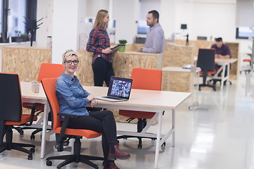 Image showing portrait of young business woman at office with team in backgrou