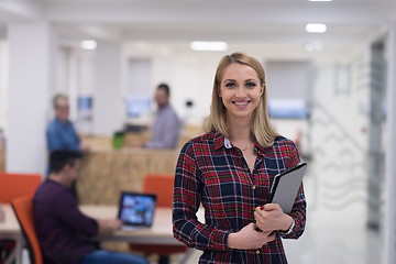 Image showing portrait of young business woman at office with team in backgrou