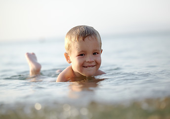 Image showing Smiling little boy in the sea