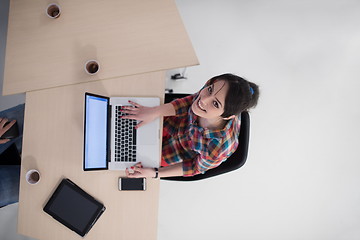 Image showing top view of young business woman working on laptop