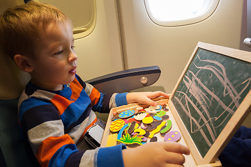 Image showing Boy in the plane drawing on board with chalk