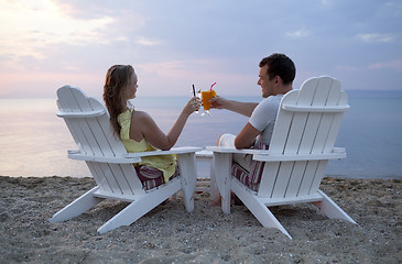 Image showing Romantic couple toasting the sunset