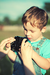 Image showing Mother helping her son to make his first photos