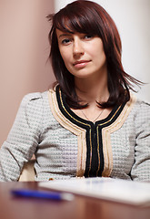 Image showing Attractive woman sitting in the office