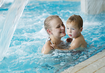 Image showing Mother and her son in the swimming pool.