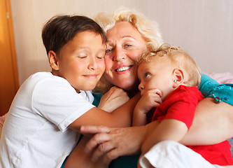 Image showing Happy grandmother hugging with her grandsons