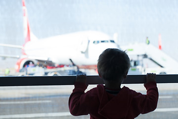 Image showing Little boy watching planes at the airport