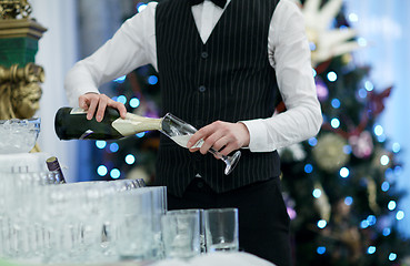 Image showing Waiter pouring glasses of champagne