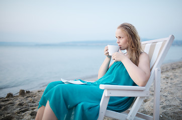 Image showing Woman enjoying a cup of tea at the seaside