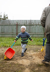 Image showing Happy grandson runs with grandfather