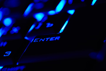 Image showing Enter key in a blue light. Macro shot.