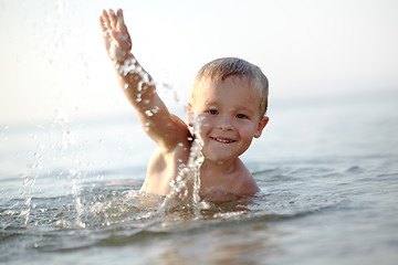 Image showing Smiling little boy in the sea