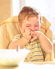 Image showing Little boy doesn\'t want to eat porridge.