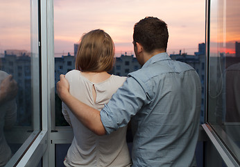 Image showing Young couple on the balcony watching sunset