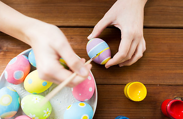 Image showing close up of woman hands coloring easter eggs