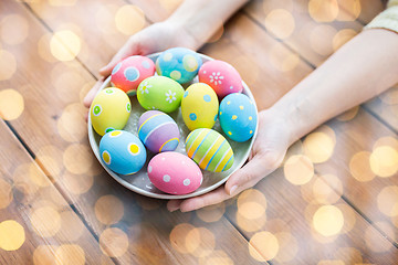 Image showing close up of woman hands with colored easter eggs