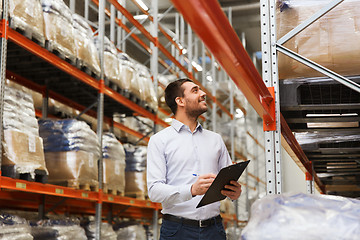 Image showing businessman with clipboard at warehouse