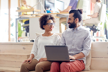 Image showing happy creative team with laptop in office