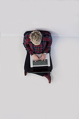 Image showing top view of young business woman working on laptop computer