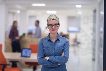 Image showing portrait of young business woman at office with team in backgrou