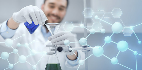 Image showing close up of scientist with test tubes and funnel