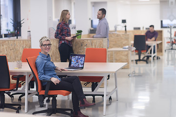 Image showing portrait of young business woman at office with team in backgrou