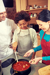 Image showing happy women and chef cook cooking in kitchen