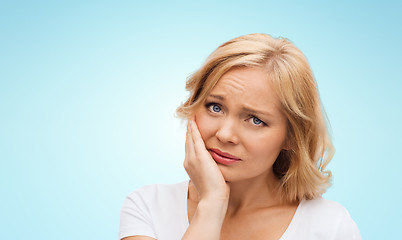 Image showing unhappy woman suffering toothache