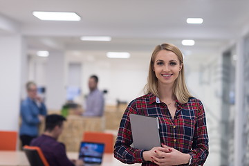 Image showing portrait of young business woman at office with team in backgrou